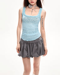 A coquette aesthetic grey mini skirt with a high-waist design and voluminous, pleated structure. The skirt features a puffy silhouette with a bubble hem for a unique look