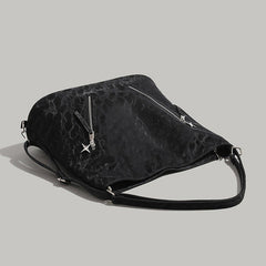 Aesthetic shoulder bag in black with a sleek design and front zipper & stars detail - boogzel clothing
