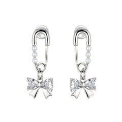 Silver-tone safety pin earrings with three small pearls leading to a sparkling crystal bow
