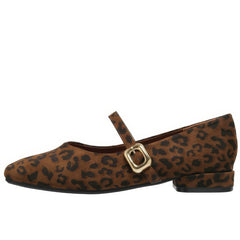 This aesthetic Mary Jane shoe featuring a square toe, low block heel, and soft suede-like surface. Designed with a slim strap and shiny gold buckle