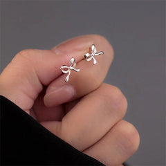 silver bow stud earrings boogzel clothing