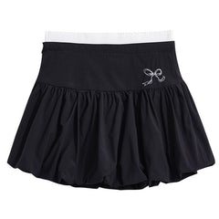 A coquette aesthetic lack mini skirt with a high-waist design and voluminous, pleated structure. The skirt features a puffy silhouette with a bubble hem for a unique look