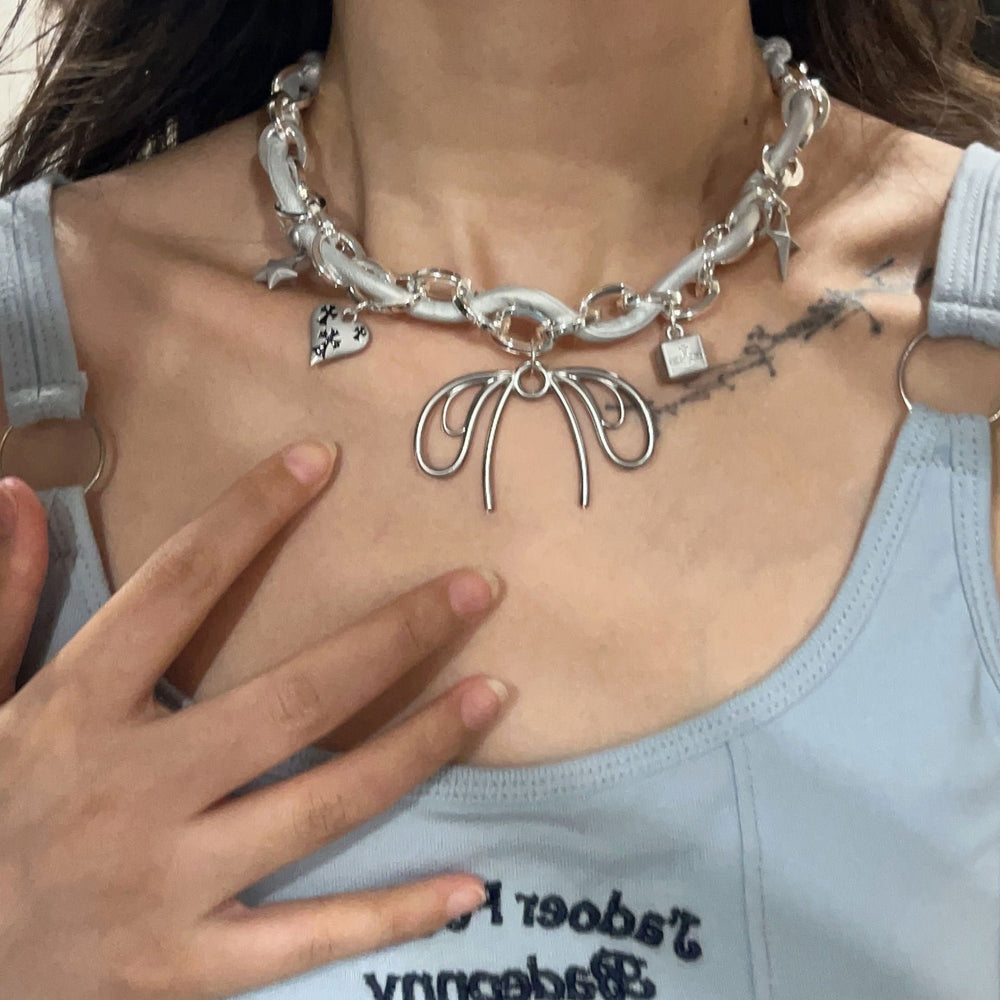 Our Coquette Chunky Necklace features a bold silver chain with bow, heart, and star pendants - boogzel clothing