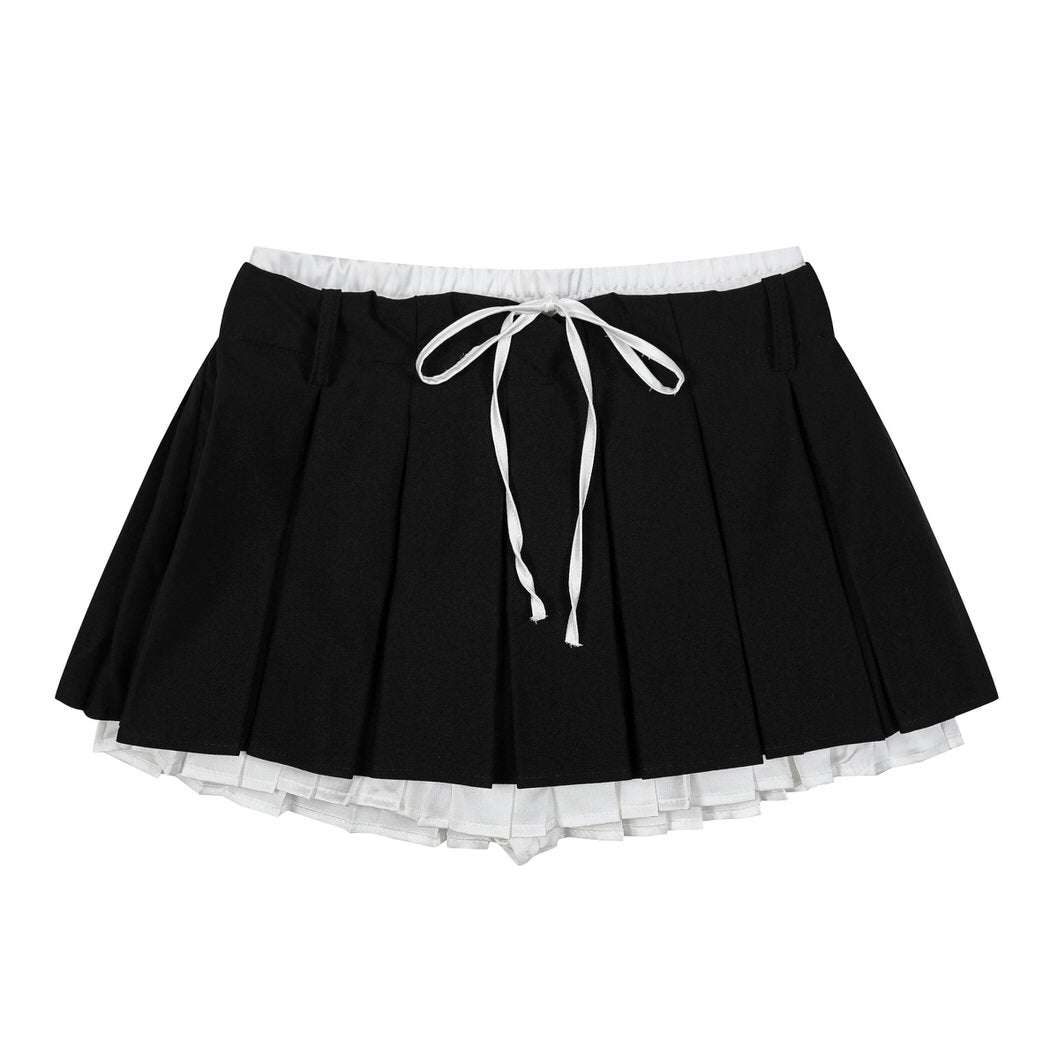This layered preppy skirt features pleated detailing with a contrast lace underskirt. The ribbon waist and layered construction give it a playful, school-girl vibe- boogzel clothing