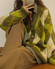 This vintage-inspired green oversized cardigan has a soft knit construction, an argyle pattern all over, front button closures, and long sleeves
