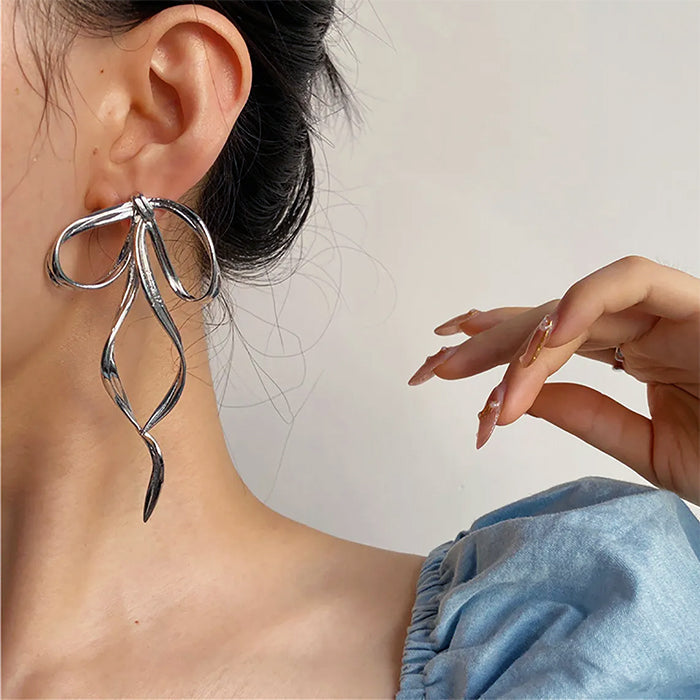 silver bow earrings boogzel clothing